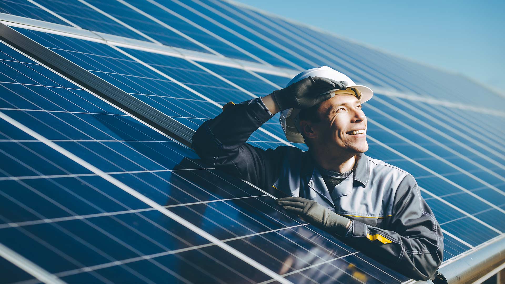 man smiling and happy with solar panels