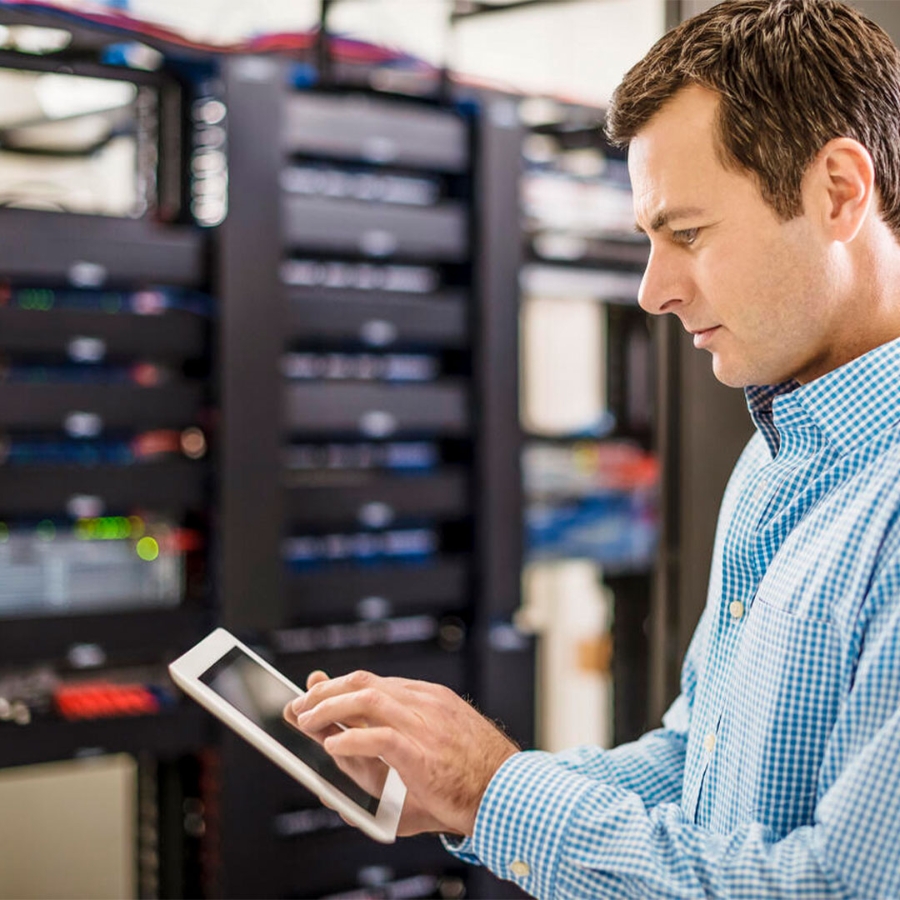 Man at server room with tablet