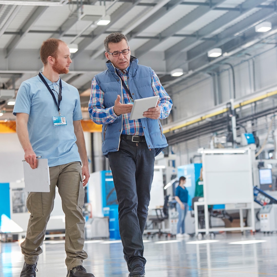 man discuss with team member in factory