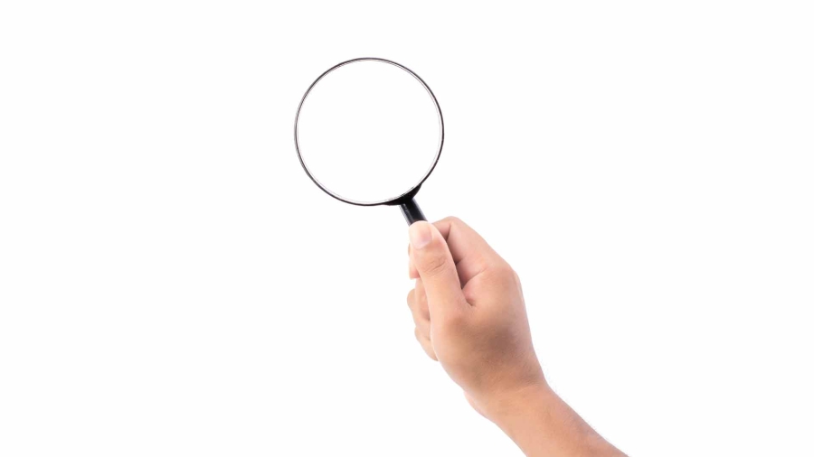 hand holding a magnifying glass