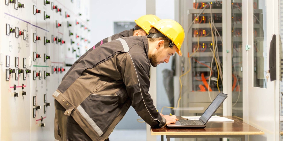 electrical engineers working on laptop devices in site