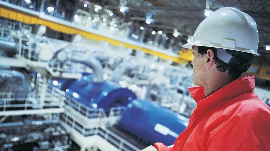 Man wearing hard hat inside a factory