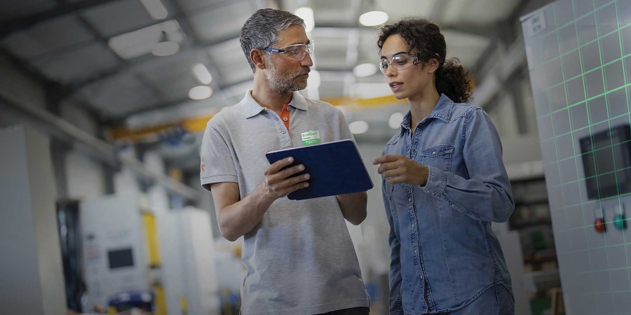 A person and person standing in a factory