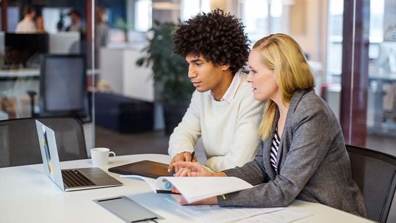 two people looking at a computer