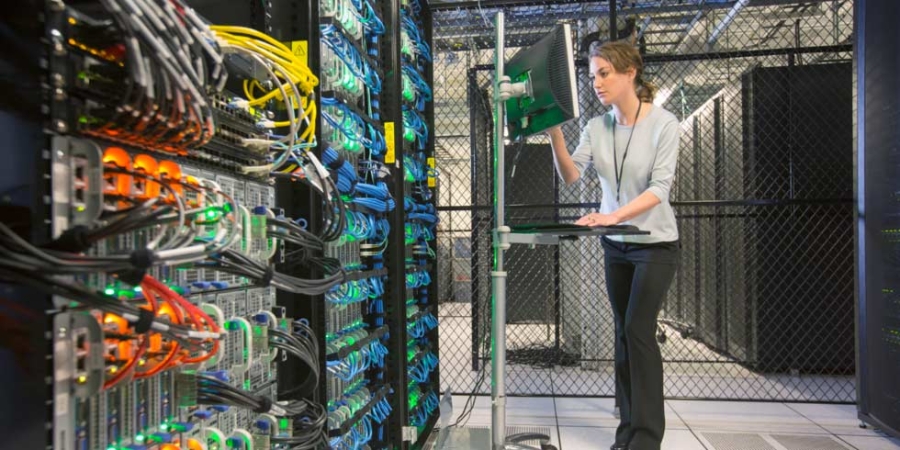 Server room technician at terminal.